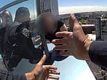 Heart-stopping moment brave cops rescue woman dangling from the roof of NYC skyscraper caught on bodycam