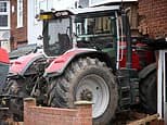 Two men arrested after masked thugs 'hotwired' farm tractor and rammed into family home at 'full throttle' in 'gangland revenge attack'